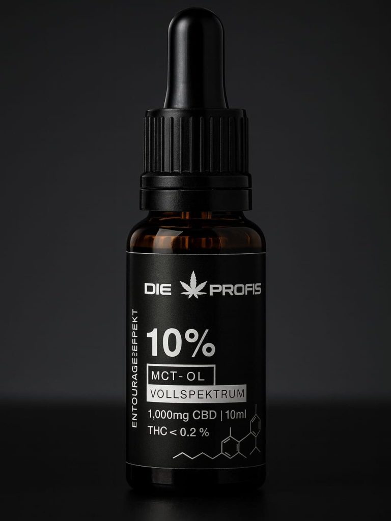 CBD-Öl Tropfendes Öl aus einem Glasbehälter unter einem Hanfblatt.